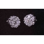 A pair of 9ct white gold flower cluster earrings set approx. 1.00 carats total weight of round