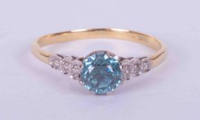 An 18ct yellow gold ring set approx. 0.93 carats of round old cut blue zircon with three small