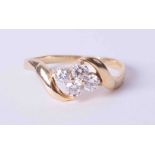 An 18ct yellow gold twist design ring set four round brilliant cut diamonds, approx. total weight