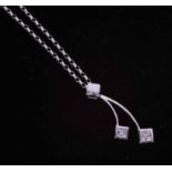 A 9ct white gold drop pendant set eight small diamonds in total with a 9ct white gold 18" fine