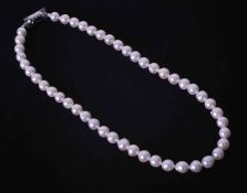 A 16" strand of white Akoya pearls with a silver push in clasp, the pearls have natural surface