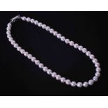 A 16" strand of white Akoya pearls with a silver push in clasp, the pearls have natural surface