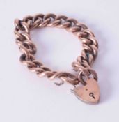 A 9ct rose gold curb link bracelet with heart padlock, weight 21.8g.