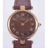 Cartier, a gold plated 'Must de' quartz wristwatch, round silver gilt cased with Roman chocolate