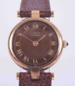 Cartier, a gold plated 'Must de' quartz wristwatch, round silver gilt cased with Roman chocolate