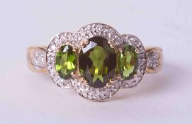 A 9ct yellow gold ring set 1.72 carats of Chrome Diopside surrounded by 0.09 carats of small round