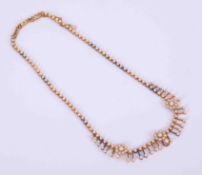 An antique 15ct yellow gold flower filigree design necklace set with small cultured pearls with push