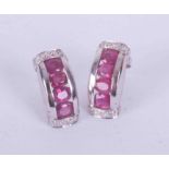 A pair of 9ct white gold earrings set oval cut rubies approx. total weight 0.96 carats with small