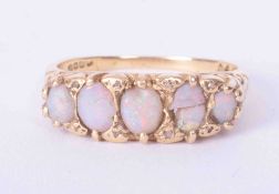 An antique 18ct yellow gold scroll design five stone opal ring (one opal broken and damage to