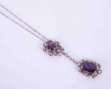 A Victorian white & yellow gold necklace (gold not tested) set with a 12mm oval amethyst & an 8mm