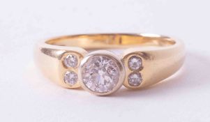 An 18ct yellow & white gold ring with a central rub-over set round brilliant cut diamond,