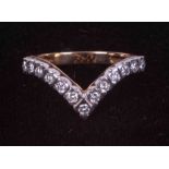 An 9ct yellow & white gold wishbone ring set with approximately 0.39 carats of round