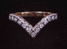 An 9ct yellow & white gold wishbone ring set with approximately 0.39 carats of round