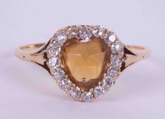 A yellow gold Edwardian ring set with a heart shaped citrine measuring approx. 6.5mm x 5.5mm