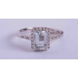 An 18ct white gold ring set central emerald cut Aquamarine approx. 1.00 carat in weight (7mm x 5mm),