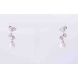 A pair of 9ct white gold leaf design drop earrings set small diamonds to the top with 6mm round