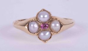 An antique gold ring (gold not tested) set with four small pearls and a small central set oval cut