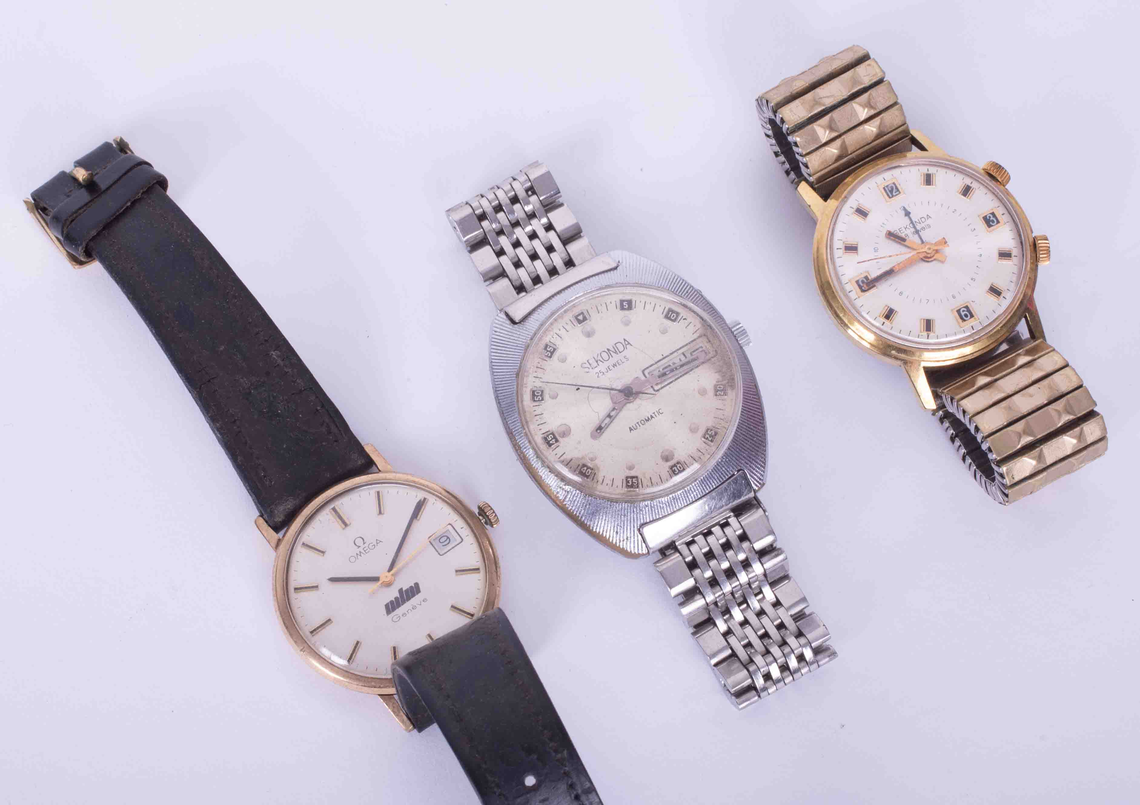 A collection of three gents wristwatches including a 9ct Omega Genève manual date, engraved to