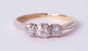 An 18ct yellow & white gold three stone ring set with approx. 0.37 carats of round old cut diamonds,