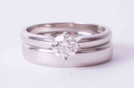 A set comprising of a platinum 4mm softly bevelled edge band, weight 6.55g, size M with