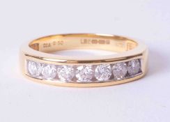 An 18ct yellow gold channel set half eternity ring set 0.50 carats of round brilliant cut