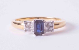 An 18ct yellow & white gold ring set approx. 0.50 carat emerald cut sapphire & 0.21ct total weight