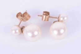 A pair of 9ct yellow gold drop pearl drop earrings with post and butterfly fittings, the pearls