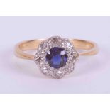 An 18ct yellow & white gold cluster ring set with an old cut round sapphire approx. 0.40 carats