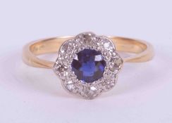 An 18ct yellow & white gold cluster ring set with an old cut round sapphire approx. 0.40 carats