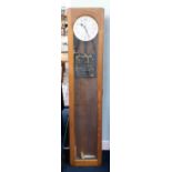 Synchronome, London, an oak cased electric master wall clock with pendulum, height 127cm x 27cm.