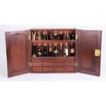 A 19th Century mahogany apothecary's cabinet with two doors enclosing a fitted interior complete