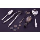 A silver baby pusher, silver and pierced ladle spoon and two silver caddy spoons and a pair of