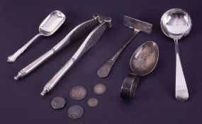 A silver baby pusher, silver and pierced ladle spoon and two silver caddy spoons and a pair of