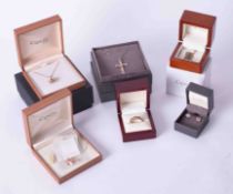 A collection of Clogau gold jewellery including pendants, necklaces, ring, & earrings.