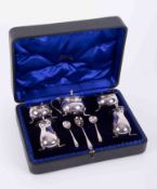 A five piece silver condiment set, with 3 spoons, maker 'GN.RH' , approx 6oz, cased.