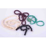 Small collection of beads including black onyx beads, jade effect beads etc.