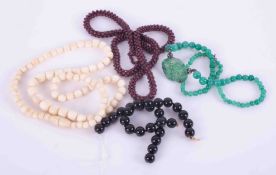 Small collection of beads including black onyx beads, jade effect beads etc.