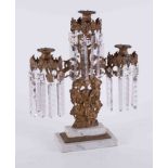 A 19th Century gilt metal candelabra with glass lustre drops on a stepped marble base, height 43cm.