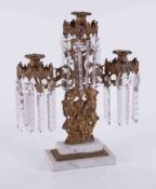 A 19th Century gilt metal candelabra with glass lustre drops on a stepped marble base, height 43cm.