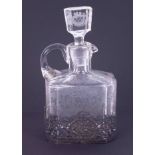 A glass spirit decanter with etched decoration and ornate pierced silver stand, Continental import