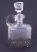 A glass spirit decanter with etched decoration and ornate pierced silver stand, Continental import