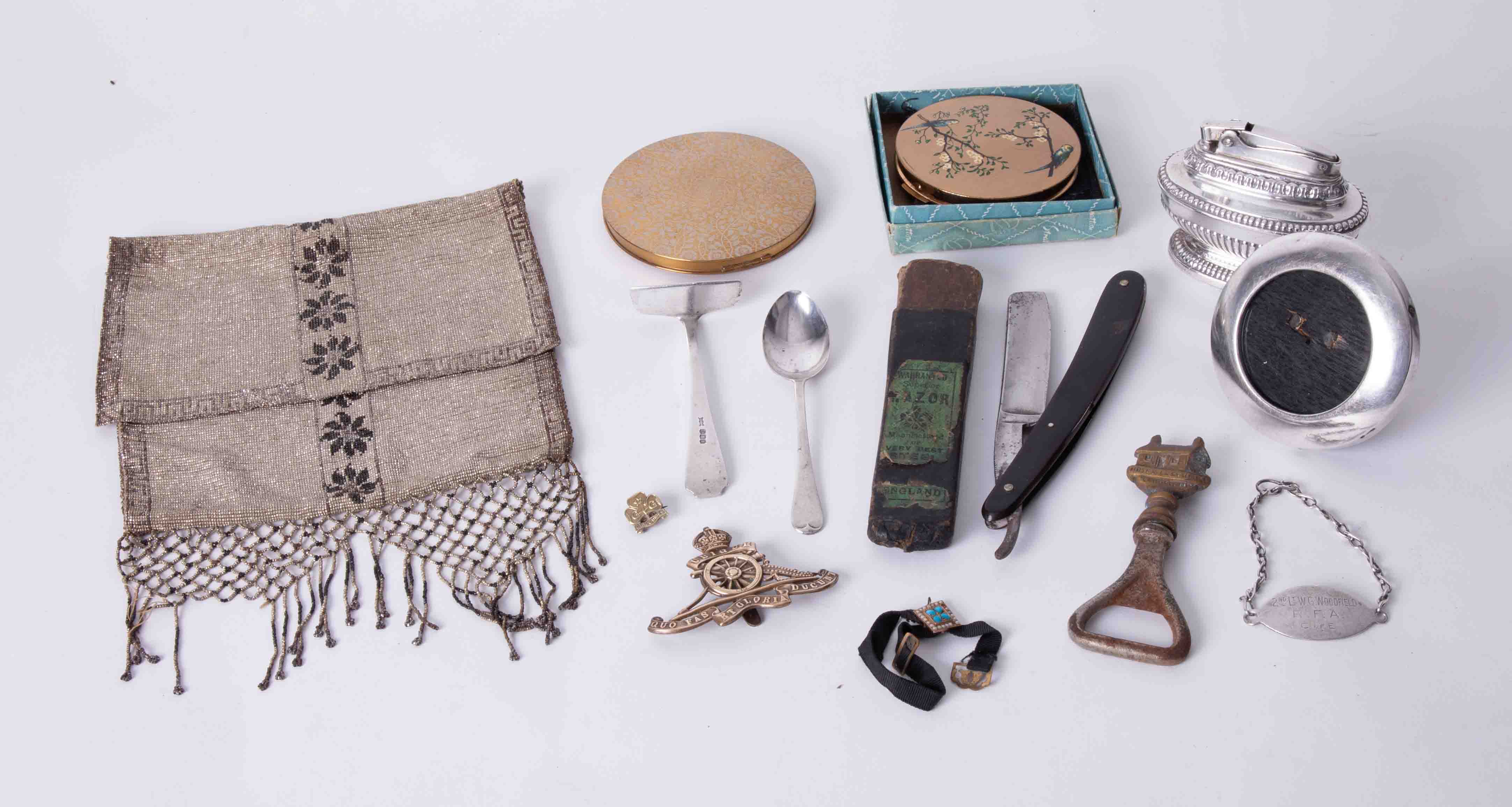 A mixed lot of powder compacts, Ronson lighter, small silver photo frame, artillery badge, razor,