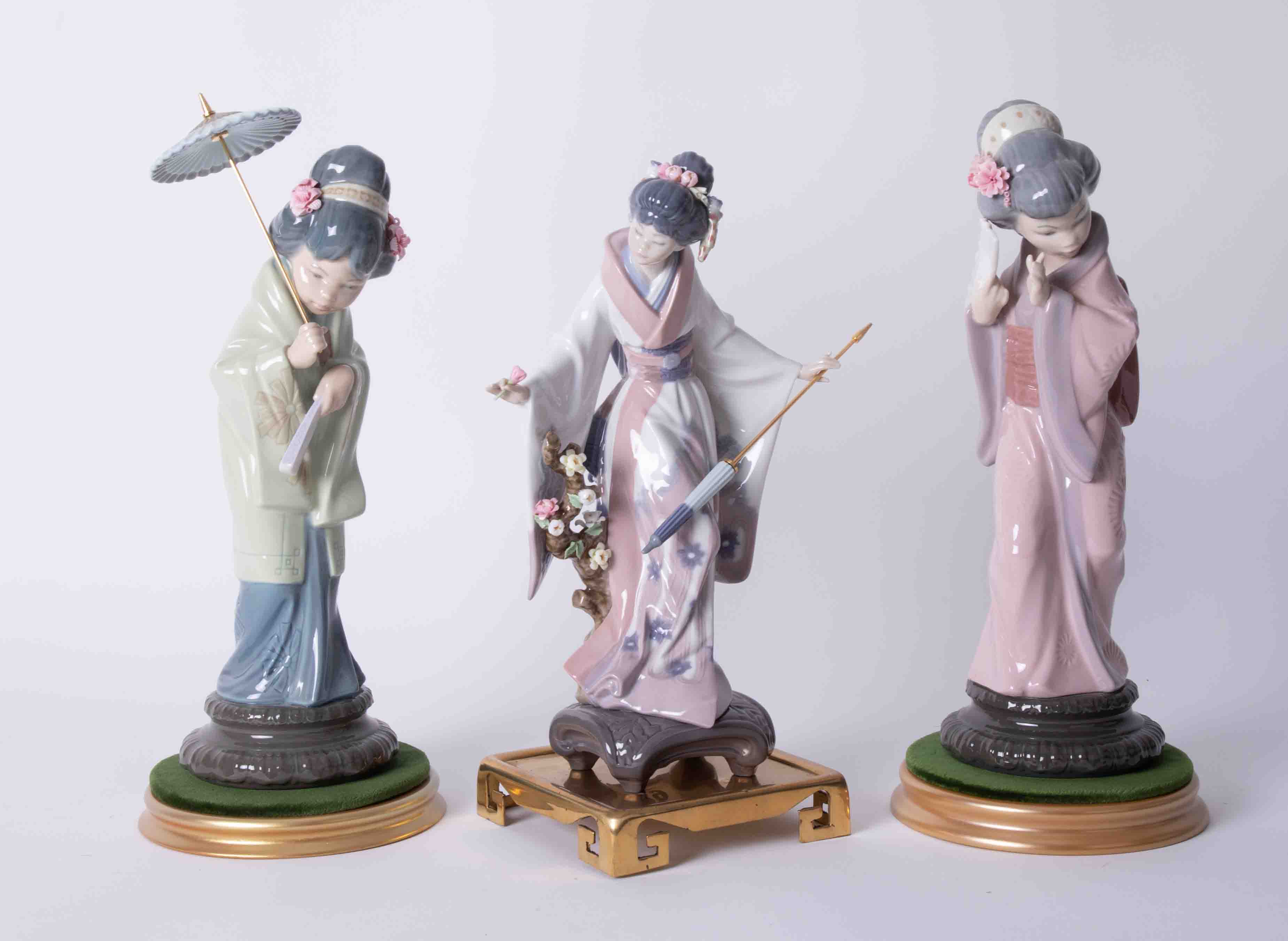 Lladro, three Oriental figures on stands, the tallest approx. 30cm, all boxed.