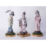 Lladro, three Oriental figures on stands, the tallest approx. 30cm, all boxed.