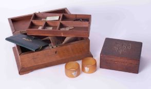 Two wooden sewing boxes one with a carved coat of arms also a pair of napkin rings with silver