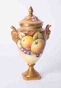 Coalport, a porcelain vase decorated with fruits, signed N Lear with cover, height 22cm.