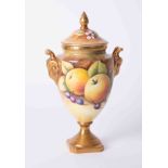 Coalport, a porcelain vase decorated with fruits, signed N Lear with cover, height 22cm.