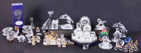 A collection of glassware mainly Swarovski cut glass including small Owl, Dolphin on a Wave etc (