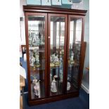 A modern freestanding two door display cabinet, fitted with glass shelves, mirror interior and