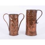Two Art Nouveau copper jugs embossed decorated with flowers, tallest 27cm